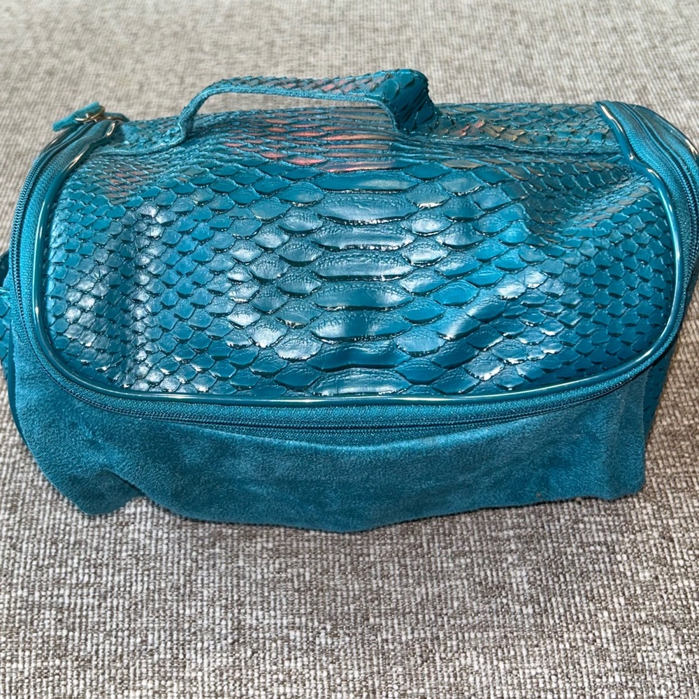 Teal cosmetic bag with wraparound zipper